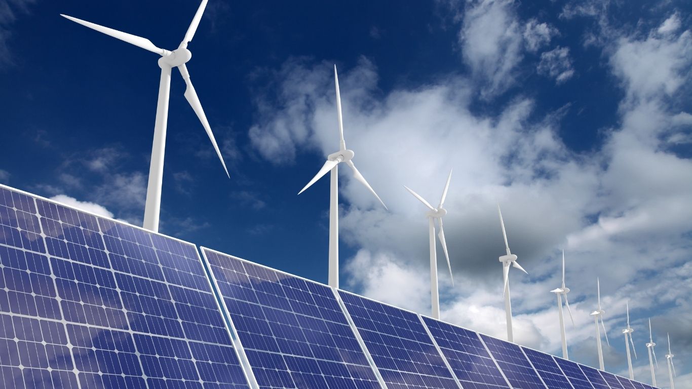 Wind turbines above solar panels generating renewable energy for cities